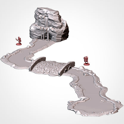 Assembled river run with a rocky spring source and a stone bridge