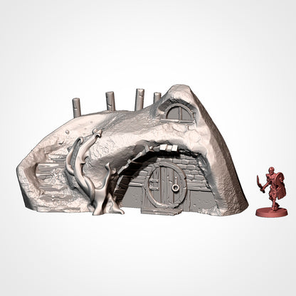 Burrow 3: front view beside a 32mm figure, stone stair, tree and post fence with a window in the hillside (Txarli Factory render).