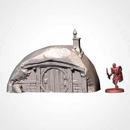 Burrow 4: front view beside a 32mm figure, spired chimney, arched lintel and a cut stump (Txarli Factory render).