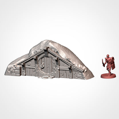 Burrow 5: front view beside a 32mm figure, steep gabled roof over the round door (Txarli Factory render).