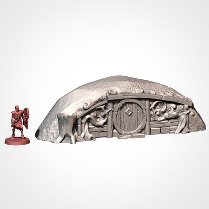 Burrow 7: front view beside a 32mm figure, low mound with a hollow stump and root-wrapped door (Txarli Factory render).