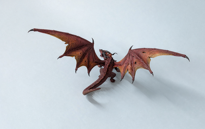 Painted ancient red dragon miniature with battle-torn wings