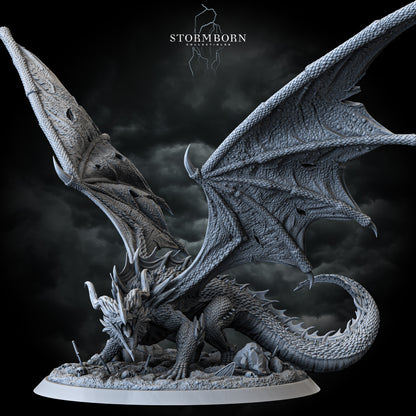 Ancient red dragon miniature with battle-torn wings on skull-strewn base