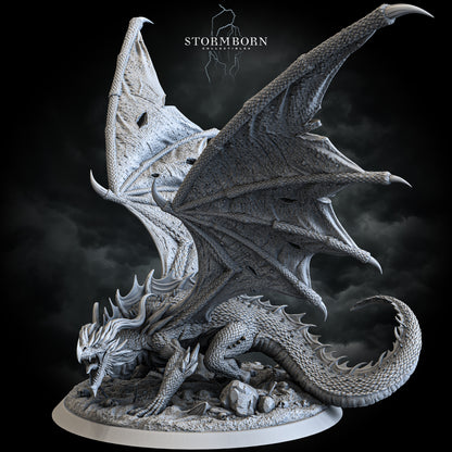 Ancient red dragon miniature with battle-torn wings on skull-strewn base