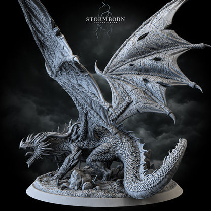 Ancient red dragon miniature with battle-torn wings on skull-strewn base