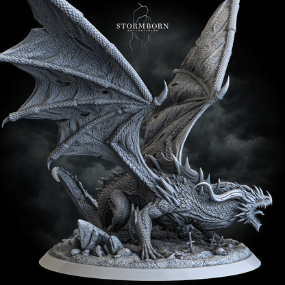 Ancient red dragon miniature with battle-torn wings on skull-strewn base