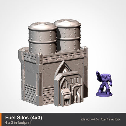 Twin industrial fuel silos terrain piece, 4 by 3 inch footprint, two cylindrical tanks on a gothic bunker base with doorway and pipes, space marine for scale. 3D printed resin gothic sci-fi wargaming terrain, unpainted, Warhammer 40K Sector Imperialis proxy scenery, designed by Txarli Factory.