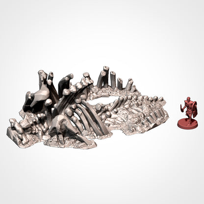 Dead giant mammoth ribcage and spine beside a 32mm miniature, scatter terrain.