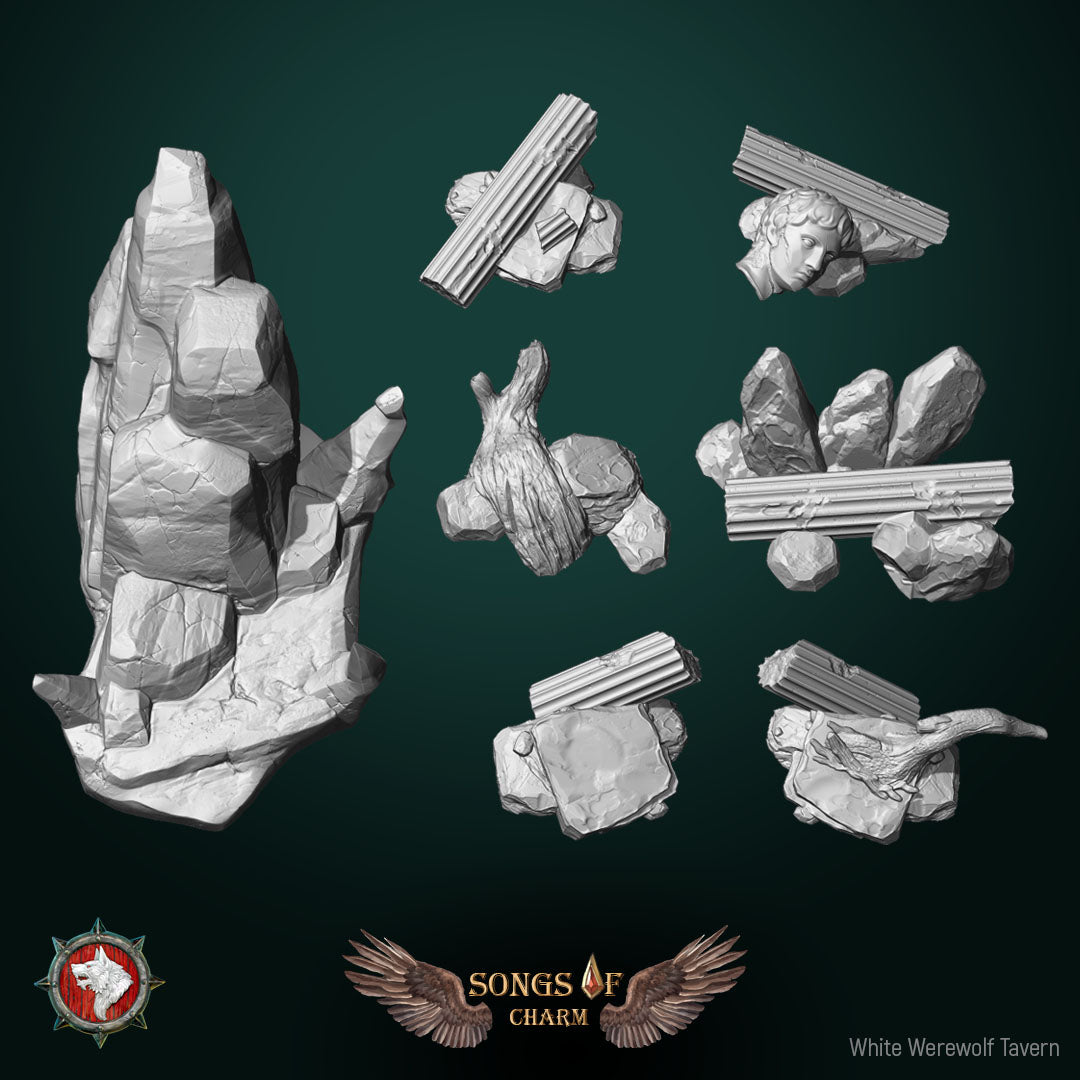 The six landscape scatter vignettes with fallen columns, rocks, driftwood and statue head